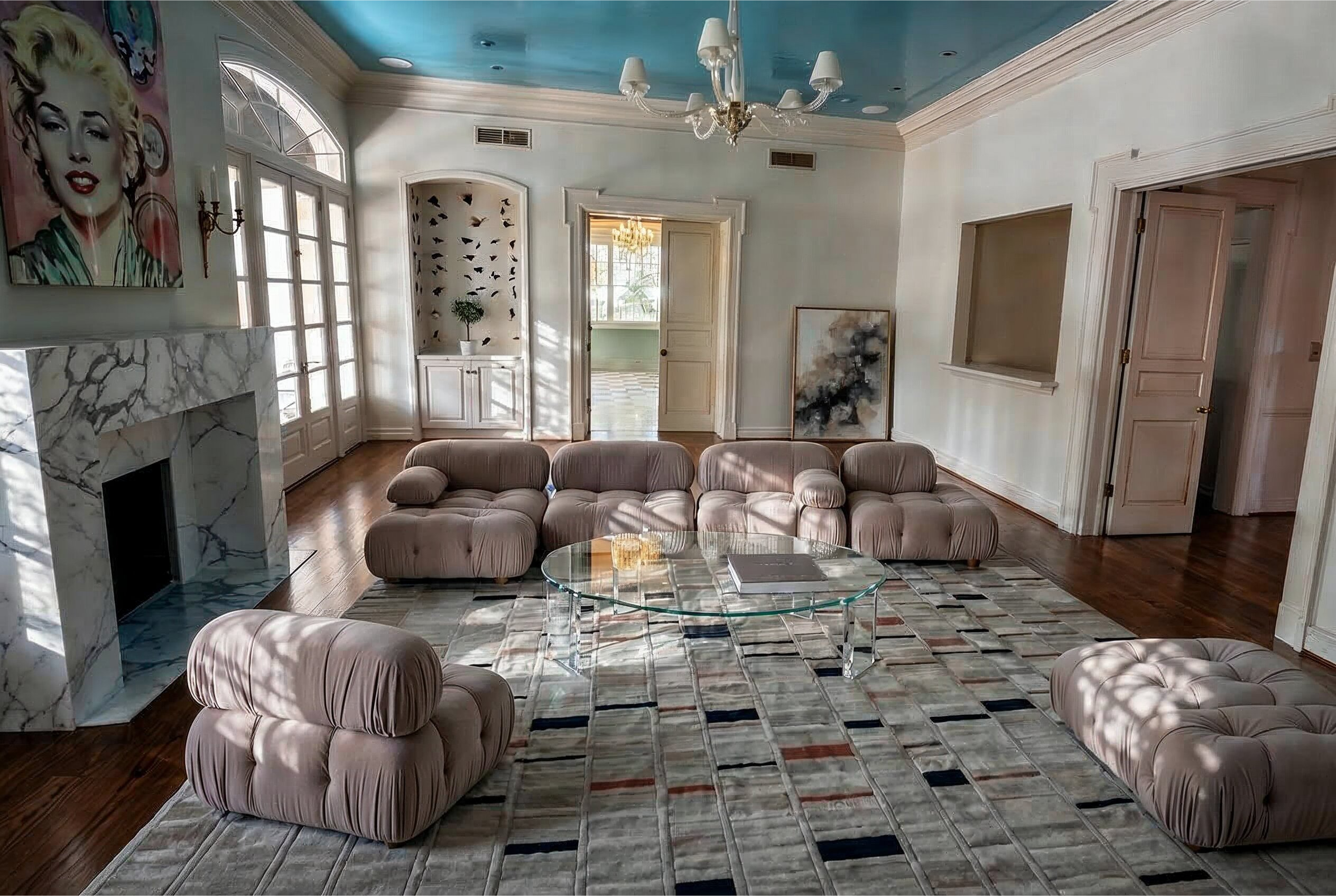 Kirby residence living room render: Camaleonda sectional in taupe velvet and cream bouclé, polished Calacatta fireplace, high-gloss lacquered ceiling, and a Kyle Bunting hide rug.